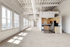 Omaha apartment for rent - the interior of an empty apartment with a kitchen and large windows