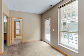 Omaha apartment for rent - a living room with a large window and a door to a balcony