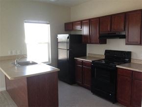 Indianapolis apartment for rent - a kitchen with a stove and a sink and a refrigerator