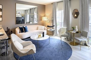 Carmel apartment for rent - a living room with white furniture and a blue rug