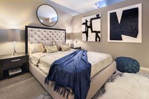 Carmel apartment for rent - A bedroom with a large bed and a blue blanket at Sophia Square Apartments, Carmel, IN