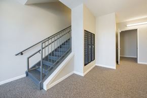 Indianapolis apartment for rent - the upstairs corridor of a building with stairs and a door