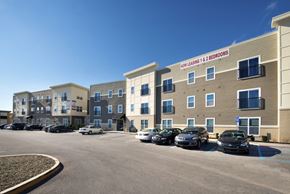 Indianapolis apartment for rent - an empty parking lot in front of a hotel with cars parked