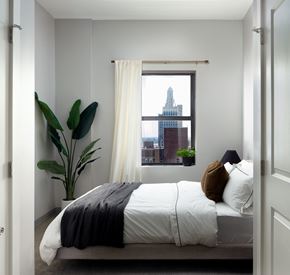 Kansas City apartment for rent - a small bedroom with a bed and a window