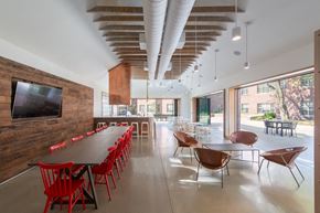 Washington apartment for rent - a dining room with a long table and chairs and a television