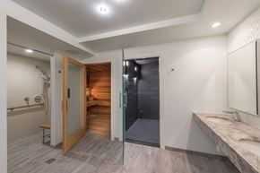 Washington apartment for rent - A bathroom with a walk-in shower and a wooden door.