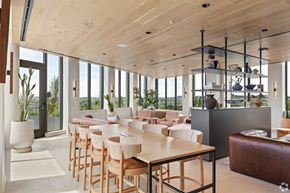 Washington apartment for rent - A modern dining room with wooden chairs and a long table.