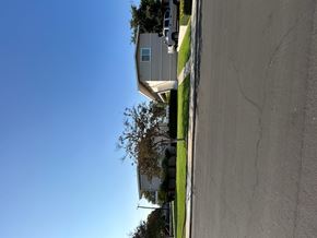 Claremont multi-family for rent - A house with a grey roof and a green lawn.