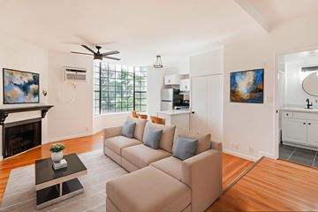 Tujunga multi-family for rent - A living room with a beige couch and a coffee table.