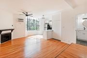 Tujunga multi-family for rent - A spacious kitchen with white cabinets and a wooden floor.