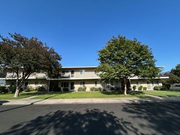Claremont multi-family for rent - A large building with a tree in front of it.
