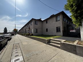 Azusa multi-family for rent - A sunny day in a residential area with houses on one side and a sidewalk with a series of names on it.