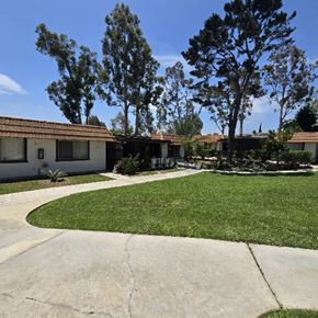 San Ysidro apartment for rent - A house with a white fence and a green lawn.