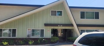 Arcadia multi-family for rent - A green building with the number 818 on it.