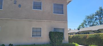 Arcadia multi-family for rent - A beige building with the number 28 on it.