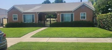 Arcadia apartment for rent - A small house with a brown roof and a green lawn in front.