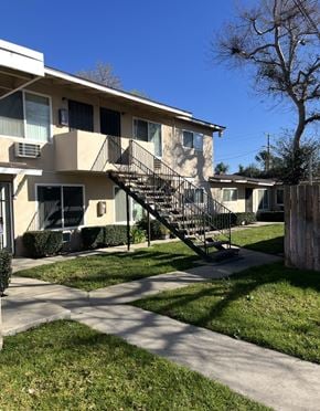 Upland multi-family for rent - A building with a black metal staircase in front of it.