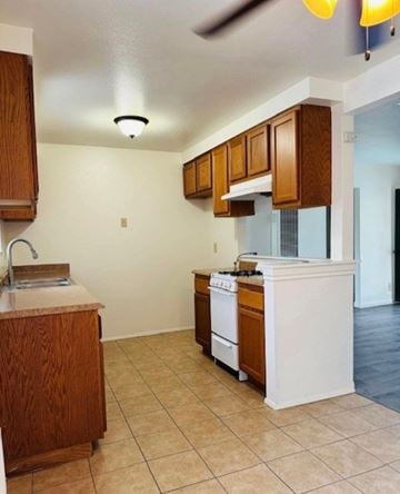 Glendora multi-family for rent - A kitchen with a white stove and wooden cabinets.