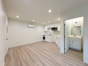 Claremont multi-family for rent - A spacious room with a washer and dryer in it.