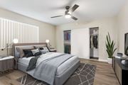 Pomona multi-family for rent - A bedroom with a large bed and a ceiling fan.