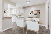 Pomona multi-family for rent - A kitchen with a dining table and chairs.