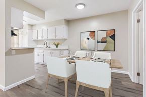 Pomona multi-family for rent - A kitchen with a dining table and chairs.