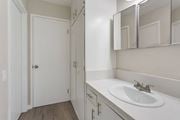 Pomona multi-family for rent - A white bathroom with a sink and mirror.