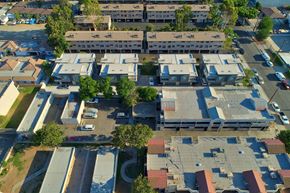 South El Monte multi-family for rent - A bird's eye view of a residential area with houses and cars.