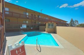 Sylmar multi-family for rent - A pool with a sign that says social distancing.