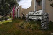 Hemet multi-family for rent - A sign for River Rock Studios and 2 Bedrooms is displayed in front of a building.