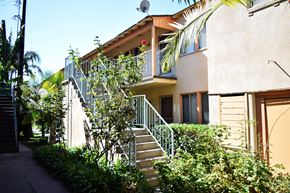 Huntington Park multi-family for rent - A building with a staircase and a balcony.