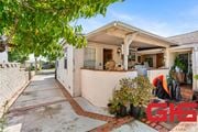 Pasadena apartment for rent - A house with a white exterior and a red brick walkway is for sale.