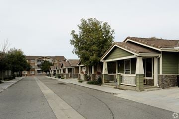 Riverside multi-family for rent - A row of houses with a tree in front of them.