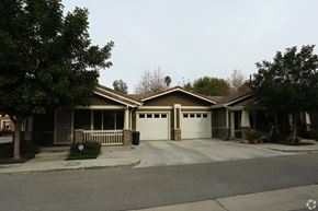 Riverside multi-family for rent - A house with a brown roof and a white garage door.