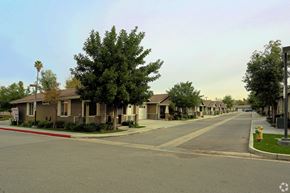 Riverside multi-family for rent - A street view of a residential area with houses on both sides.
