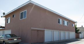 Gardena multi-family for rent - A brown house with a car parked in front.