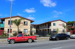 Sun Valley multi-family for rent - A red pickup truck is parked on the side of the road in front of a house.