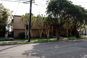 Inglewood multi-family for rent - A street view with a building, trees, and a utility pole.