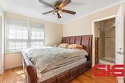 Pasadena apartment for rent - A bedroom with a bed, a ceiling fan, and a door leading to a bathroom.