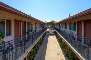 Baldwin Park multi-family for rent - A long row of houses with balconies and plants.