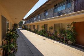 Baldwin Park multi-family for rent - A long, narrow balcony with a railing runs the length of a building.