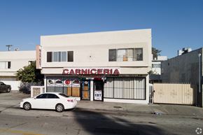 Inglewood apartment for rent - A white car is parked in front of a Carnicería.