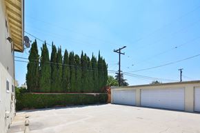 Downey multi-family for rent - A clear blue sky above a row of garages.