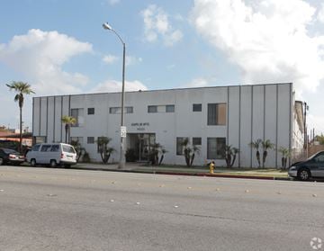 Bellflower multi-family for rent - A white building with the name "Maple Hill" on it.