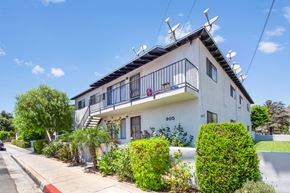 Azusa apartment for rent - A white house with a balcony and a black railing.