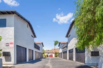 Azusa apartment for rent - A row of white buildings with a red door in the middle.