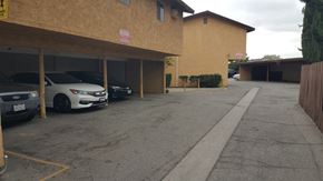 Montebello multi-family for rent - A parking lot with a white car parked in the middle.