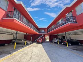 Lynwood multi-family for rent - A parking lot with cars parked in it.