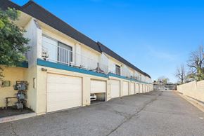 Upland multi-family for rent - A row of garage doors in front of a building.