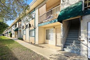 Upland multi-family for rent - A row of apartment buildings with green awnings.